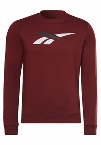 Sweatshirt marron en tissu doux avec un col rond, présentant un grand logo blanc et noir sur le devant et des poignets côtelés.