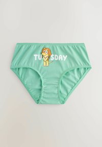 Sous-vêtements féminins vert clair avec un chien de dessin animé portant un soutien-gorge et le mot « TUESDAY » en lettres blanches.