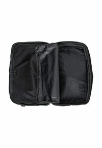Black travel bag, rectangular shape. Interior features a smooth, glossy surface and a mesh pocket. Unzipped for accessibility.