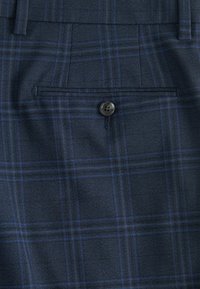 Navy blue plaid fabric featuring a textured weave with light blue lines. Includes a back pocket with a button closure.
