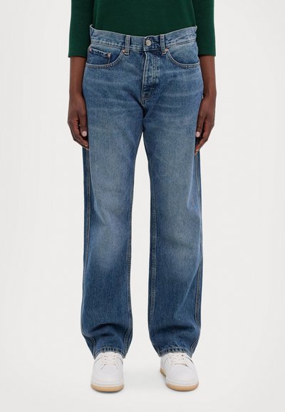 Blue denim jeans with a relaxed fit and wide legs, featuring copper rivet accents, five pockets, and a classic button closure.