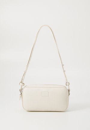 Crème faux leren schoudertas met een rechthoekige vorm, ritsafsluiting, verstelbare schouderband en subtiele logodetail aan de voorkant.
