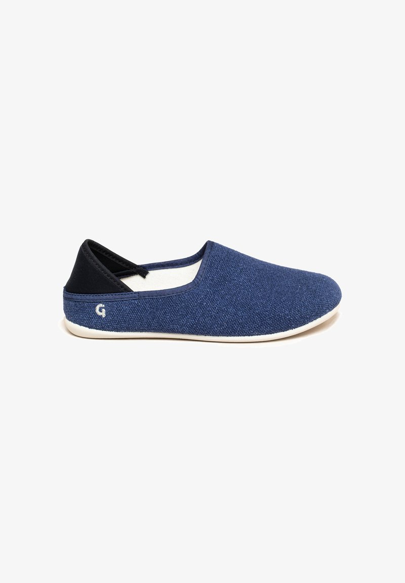 Navy blue slip-on shoes made of textured fabric with contrasting black heel and light sole. Features a small logo on the side.