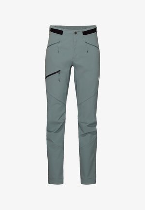 Pantalons d'extérieur gris clair en tissu flexible. Comprend des poches zippées, des fermetures éclairs noires contrastantes et une coupe épurée avec des coutures incurvées.
