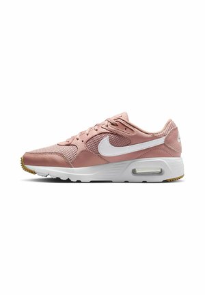 Zapatillas Nike rosas con parte superior de malla y cuero, swoosh blanco, amortiguación de aire visible en el talón y suela de goma texturizada.
