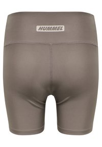 Brown athletic shorts made of elastic material with a logo tag on the waistband. Features flatlock seams for comfort and fit.