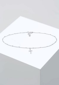 Silver chain necklace with beaded accents and a small cross pendant. Simple, delicate design with a clasp for closure.