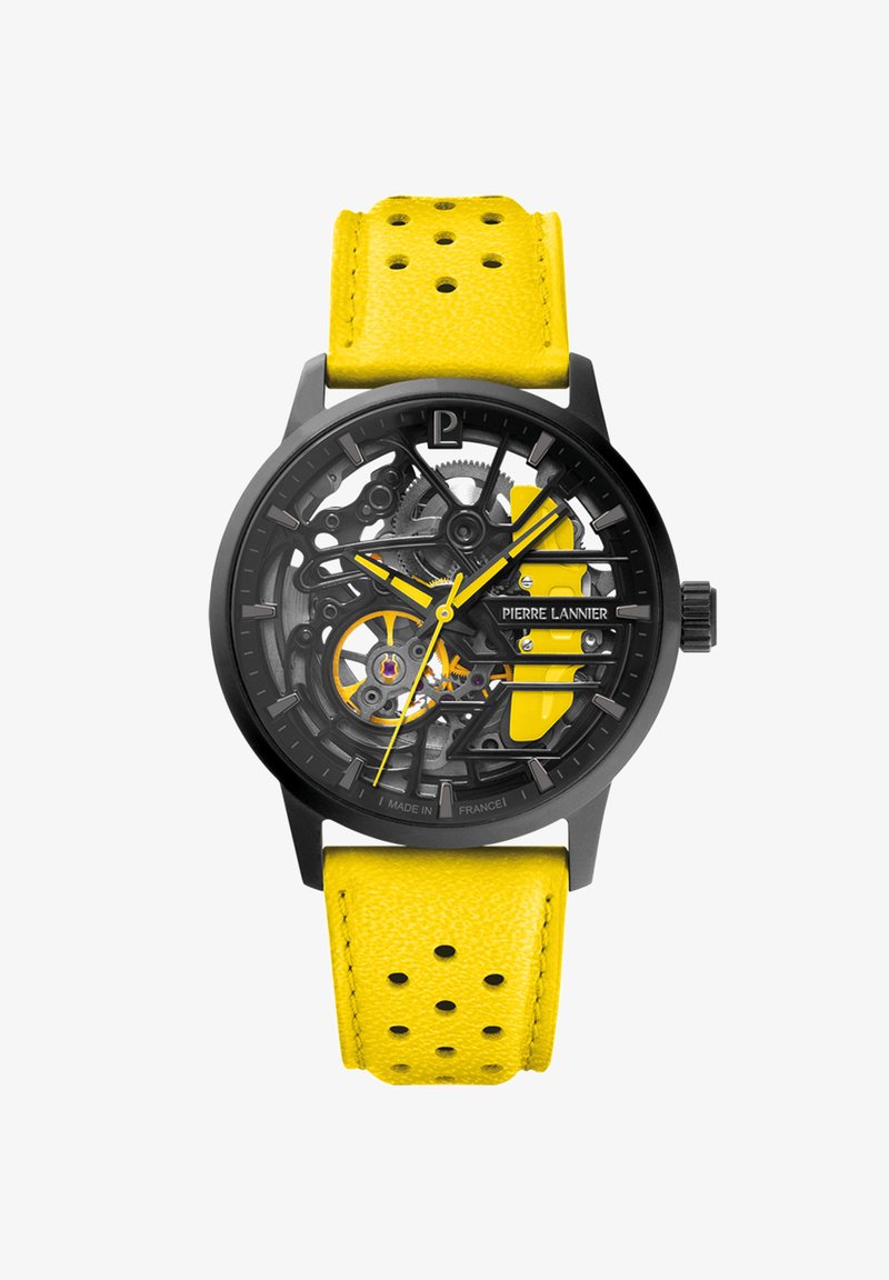 Orologio scheletrico nero con cinturino in pelle gialla dotato di perforazioni. Accenti gialli sul quadrante migliorano la visibilità degli ingranaggi e dei marcatori.