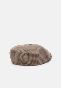 Căciulă texturată în nuanțe de maro și bej, cu un model houndstooth, având o formă rotundă, un buton mic în partea de sus și o margine ușor curbă.