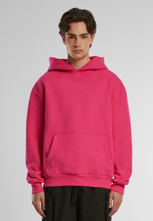 Sudadera con capucha de un brillante color rosa, hecha de algodón, que cuenta con un bolsillo canguro, puños acanalados y dobladillo con un ajuste relajado.