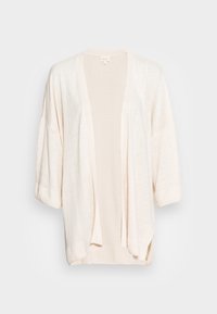 Cardigan beige clair en matière douce et texturée. Il présente un devant ouvert, des manches amples et une silhouette décontractée.