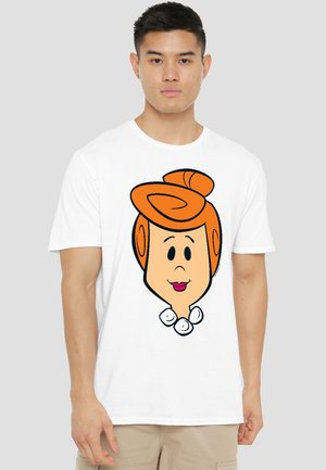 Young man wearing a white T-shirt featuring a cartoon female face with orange hair styled in a bun and a white pearl necklace.