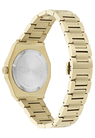 Reloj de acero inoxidable dorado con una caja octagonal. Cuenta con una correa cepillada y pulida, cristal de zafiro y logo de la marca grabado en la parte posterior.