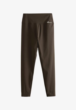Brown athletic leggings with a wide waistband. Made of stretchy fabric, featuring a smooth texture and a small logo on the waistband.