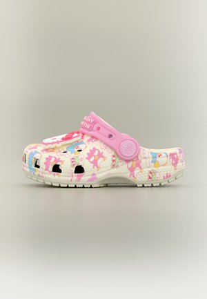 Sabot enfant avec bride rose, avec des motifs colorés de personnages de dessins animés et des trous de ventilation sur un fond clair.