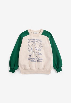 Sweat-shirt enfant avec manches vertes et corps beige, avec un croquis bleu d'un yéti et un texte sur les empreintes du yéti et la découverte.