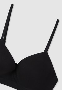 Reggiseno wireless nero con spalline sottili regolabili, tessuto morbido, coppe a copertura totale e una banda flessibile per il massimo comfort.