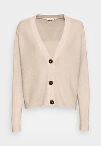 Beige gebreid vest met een V-hals, lange mouwen en vijf bruine knopen aan de voorkant. Zachte textuur, cropped ontwerp.