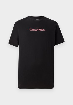Black short-sleeve t-shirt made of cotton, featuring a central Calvin Klein logo in red and white, with a crew neck and relaxed fit.