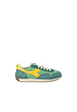 Low-top sneaker in green fabric and suede with yellow side logo, white laces, and brown rubber sole, displayed in side profile.
