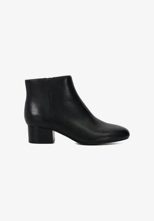 Bottine noire en cuir lisse, avec un bout arrondi et un petit talon empilé. Design minimaliste avec une fermeture éclair à l'arrière.