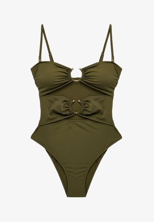 Costume intero verde oliva con spalline regolabili e due ritagli circolari sul seno e sull'addome, con dettagli in tessuto arricciato.