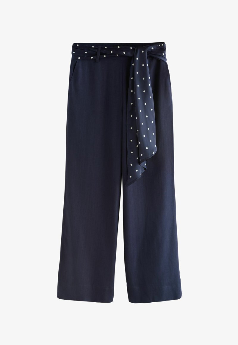 Pantalon large bleu marine avec une ceinture en tissu à pois assortie attachée à la taille, avec passants de ceinture et poches avant.