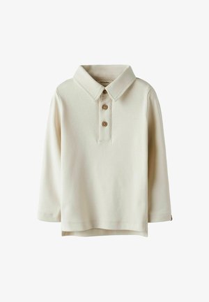 Crème lange mouwen polo-shirt met een kraag, drie houten knopen en een rechte zoom. Zachte stof met minimale textuur en zonder patronen.