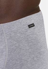 Grå bomullsboxershorts med en mjuk textur; har en svart etikett med "HANRO" på midjebandet; åtsittande design.