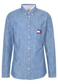 Camicia azzurro chiaro in tessuto chambray, dotata di una tasca sul petto e di un logo "Tommy Jeans" multicolore.