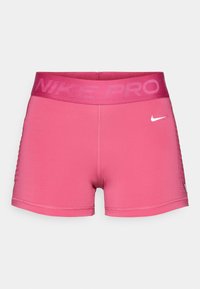Calções atléticos Nike Pro cor-de-rosa com uma cintura larga que exibe o nome da marca. Feitos de um material elástico, com uma textura suave e um pequeno detalhe com o logótipo.