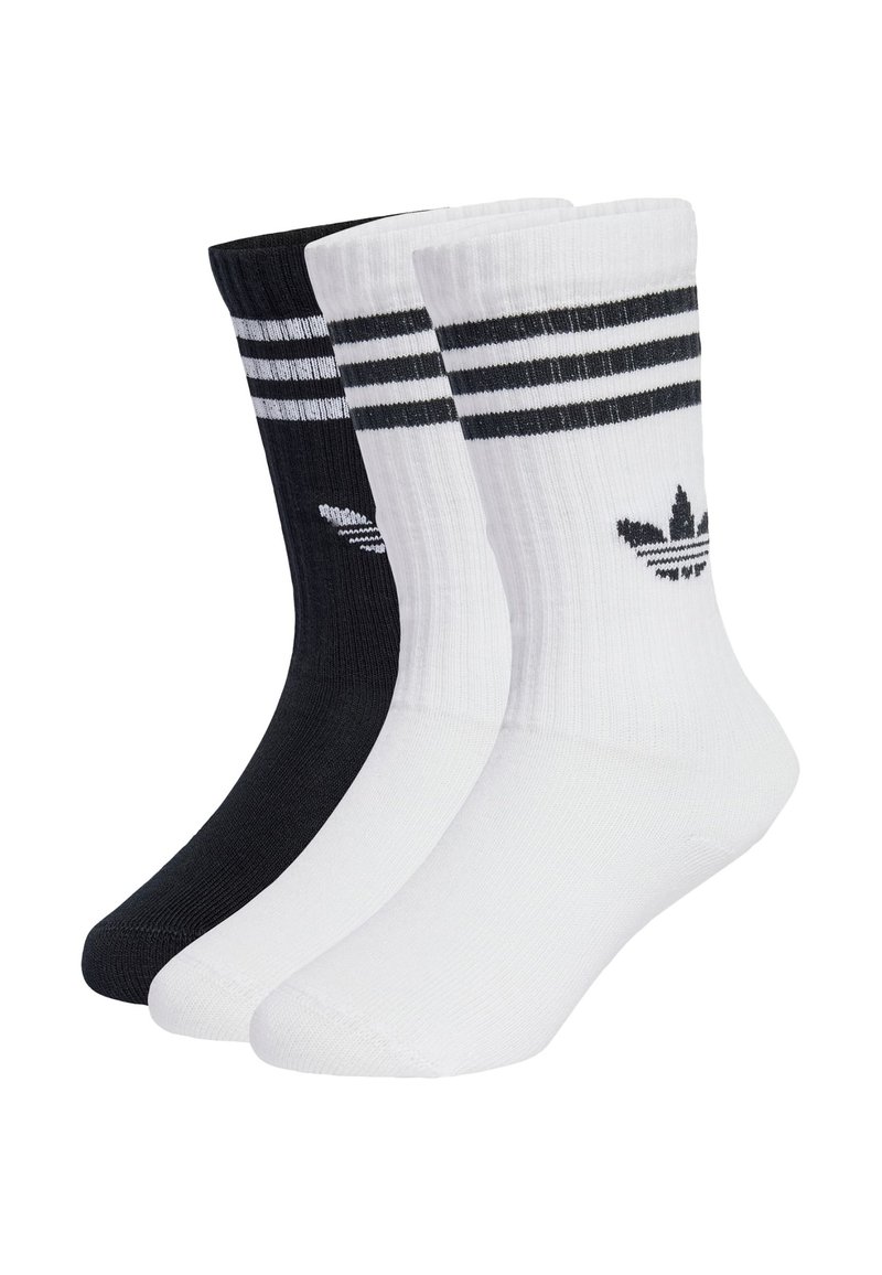 Tri páry ponožiek do členkov v čiernej a bielej farbe, s dvoma čiernymi pruhmi na vrchu a logom na každej ponožke. Vyrobené z texturovaného materiálu.