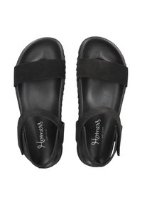 Black sandals with a smooth leather footbed and two wide fabric straps. Features a velcro closure for adjustable fit and embossed logo.