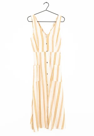 Mouwloze lange jurk met gele en witte verticale strepen, knoopsluiting aan de voorkant, twee grote voorzakken, hangend aan een zwarte hanger.