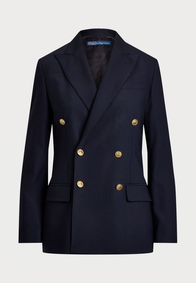 Blazer azul de duas fileiras feito de um tecido com uma textura suave. Apresenta botões dourados e dois bolsos frontais. Design ajustado com lapelas.