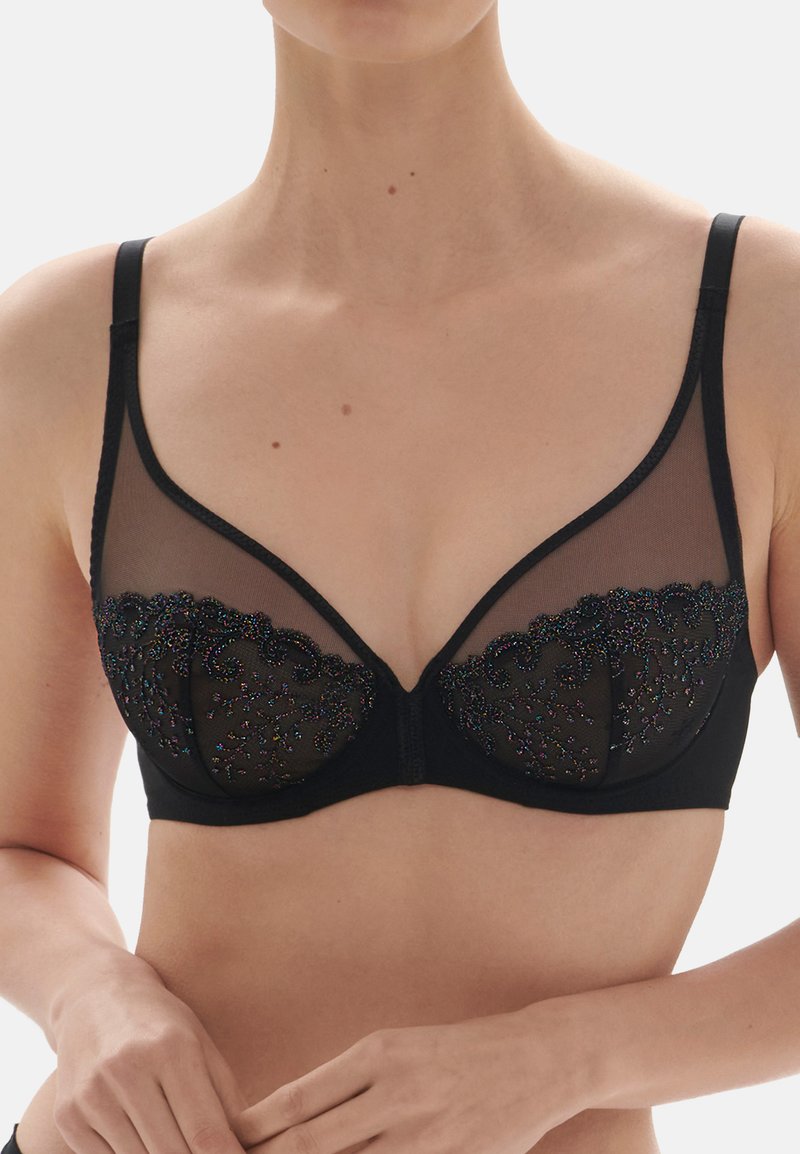 Black bra featuring sheer mesh panels and intricate embroidered accents with colorful detailing, triangle cups, and adjustable straps.