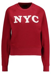 Red sweatshirt with a crew neckline, featuring white fuzzy "NYC" lettering. Ribbed cuffs and hem with a relaxed fit and soft texture.