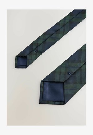 Tumerohelise ja mereväe sinise ruudulise mustriga meeste lips, millel on mereväe sinine sisemine vooder, eksponeeritud valgel taustal.