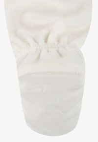 Fehér szövet kesztyű, ráncolt csuklórésszel. Puha tapintású és sima anyag, minta vagy díszítés nélkül. Szabványos kesztyűforma.