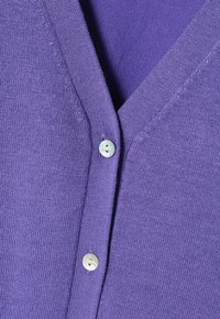 Purple knitted cardigan featuring a deep V-neck, two matching buttons, and a smooth texture. The fabric appears lightweight and breathable.