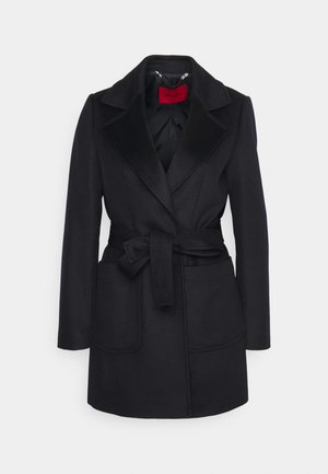 Black wool coat with a notched collar, belted waist, and two front pockets. Smooth texture with a satin interior lining and a red label.