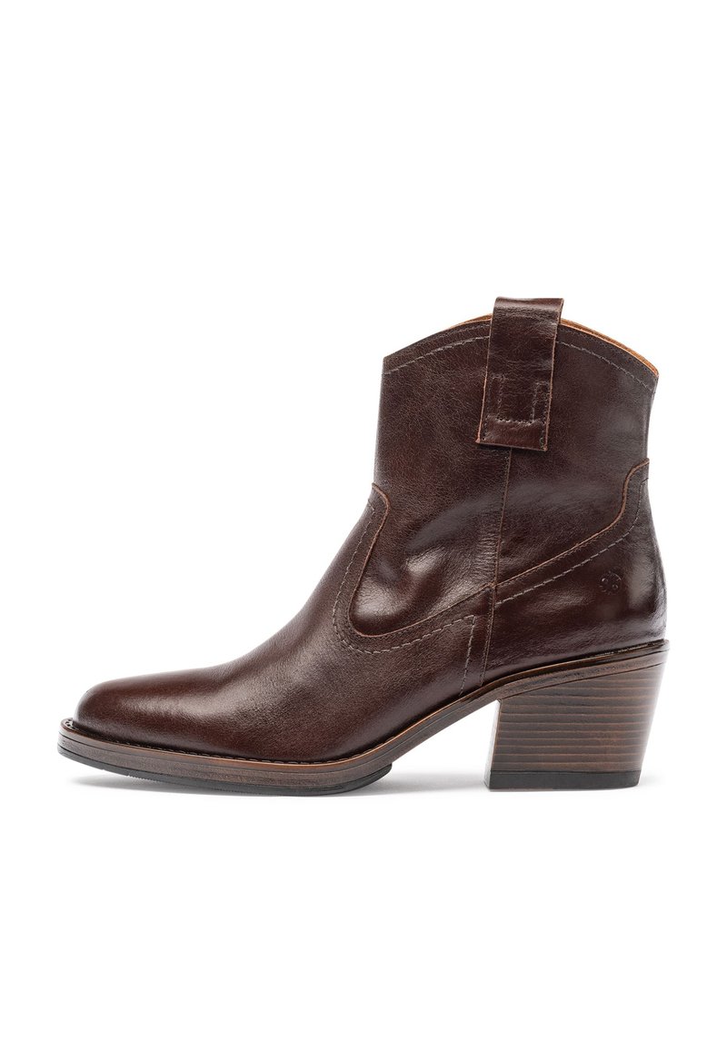 Brown leather ankle boot with a pointed toe, curved top, side cutouts, and a stacked wooden heel. Features a pull tab for easy wear.
