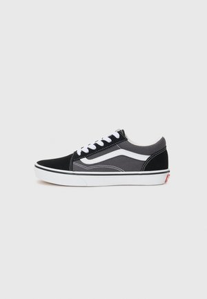 Black and gray canvas sneaker with white accents, featuring a classic lace-up design and a rubber sole. Side logo detail visible.