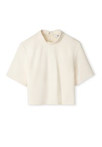 Krátký rukáv, zkrácený top z krémové látky s vysokým límcem a zipem na zádech. Vyznačuje se čistými liniemi a minimalistickým designem.