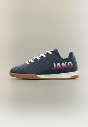 Tmavomodrá halová futbalová obuv s bielymi šnúrkami, gumovou podrážkou a logom "JAKO" v červenej a bielej farbe na boku.