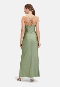 Maxikleid aus salbeigrünem Stoff mit glatter Textur, mit überkreuzten Trägern, einem Reißverschluss und einer figurschmeichelnden Passform.