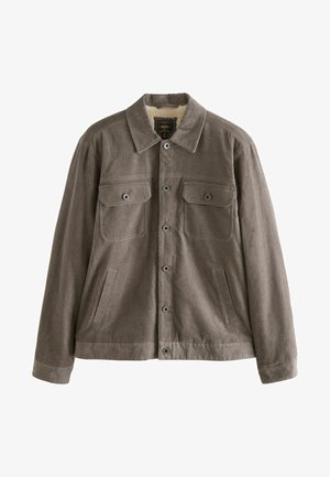 Pruun kangast jakk, millel on kraega kaelus, kaks rinna taskut, küljetaskud ja nööbiga kinnitused. Pehme tekstuuriga vooder on seest nähtav.