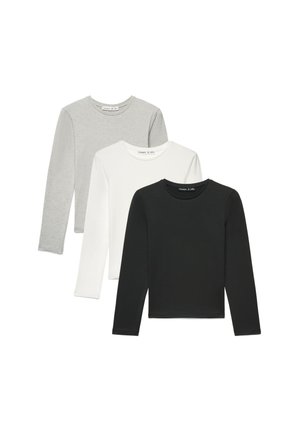 Tre magliette a manica lunga con scollo rotondo in nero, bianco e grigio chiaro, disposte sovrapposte su uno sfondo bianco.