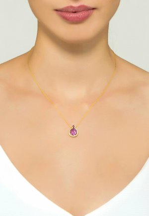 Collana d'oro con un pendente circolare impreziosito da pietre viola, che presenta dettagli intricati e una catena con una texture delicata.