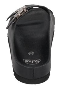 Black sandal with a smooth texture, adjustable metal buckle, and contoured footbed. Round toe and flat sole for comfort. Size 39.